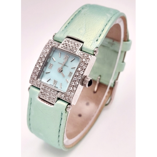 534 - A Ladies Continental Quartz Watch. Green leather strap. Stainless steel and white stone case - 22mm.... 