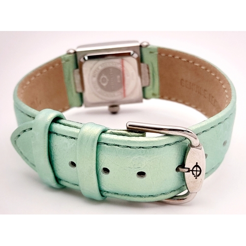 534 - A Ladies Continental Quartz Watch. Green leather strap. Stainless steel and white stone case - 22mm.... 