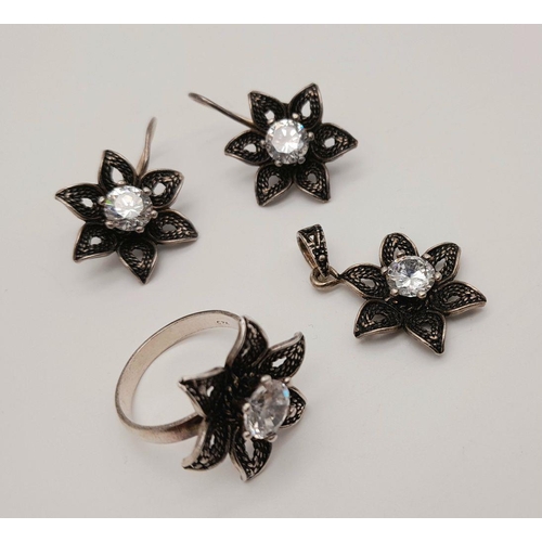 560 - A stunning set of 925 silver star designed CZ jewellery set to include a pair of earrings, a ring (S... 