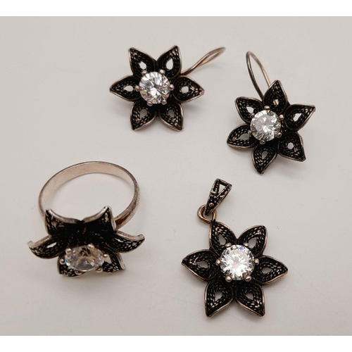 560 - A stunning set of 925 silver star designed CZ jewellery set to include a pair of earrings, a ring (S... 