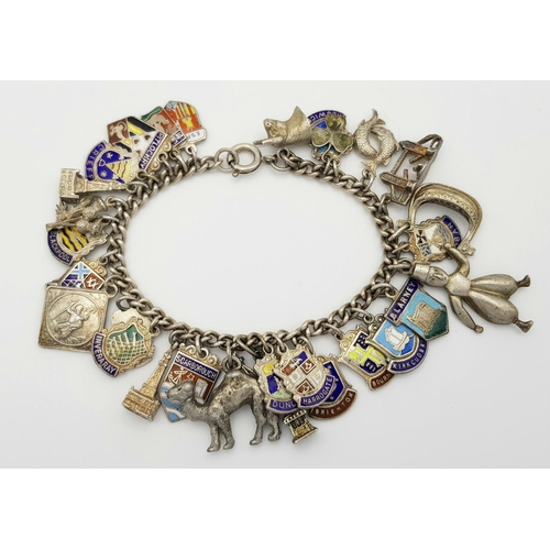 570 - A vintage Solid Silver 925 Charm Bracelet, with 28 charms, 62.5 grams, 18cm. In very good condition.