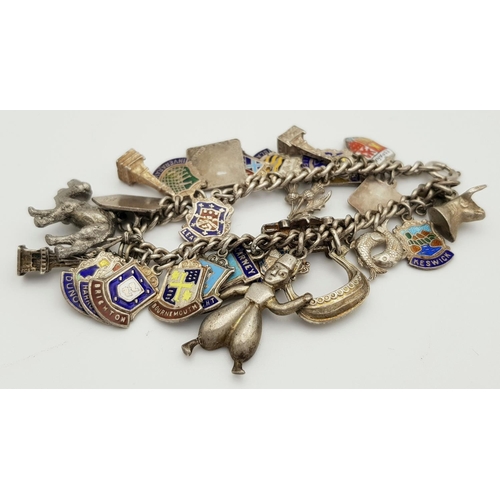 570 - A vintage Solid Silver 925 Charm Bracelet, with 28 charms, 62.5 grams, 18cm. In very good condition.