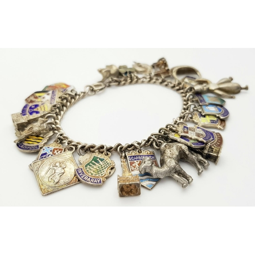 570 - A vintage Solid Silver 925 Charm Bracelet, with 28 charms, 62.5 grams, 18cm. In very good condition.