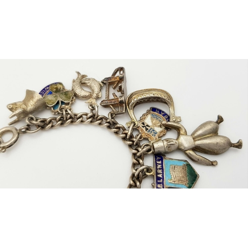 570 - A vintage Solid Silver 925 Charm Bracelet, with 28 charms, 62.5 grams, 18cm. In very good condition.