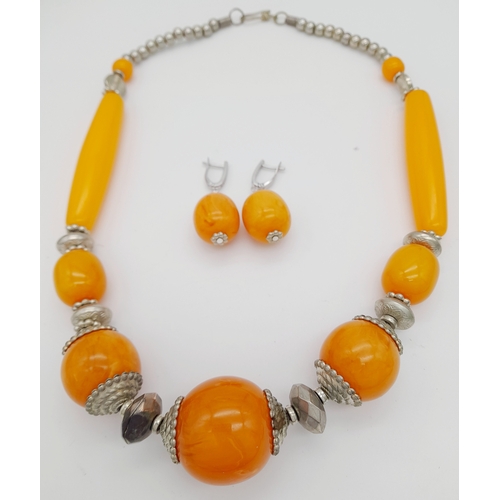 665 - A graduated orange Berber resin necklace with metal accents, and matching 925 silver earrings. Appro... 