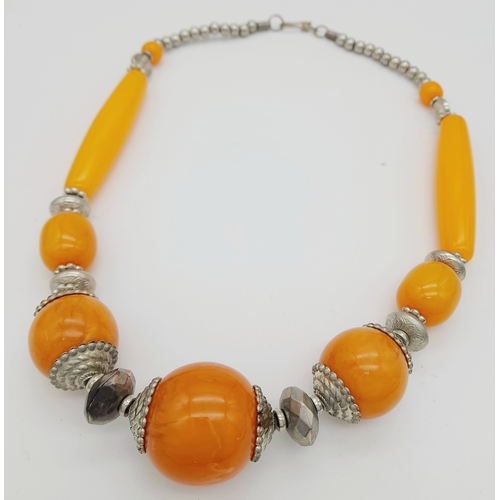 665 - A graduated orange Berber resin necklace with metal accents, and matching 925 silver earrings. Appro... 