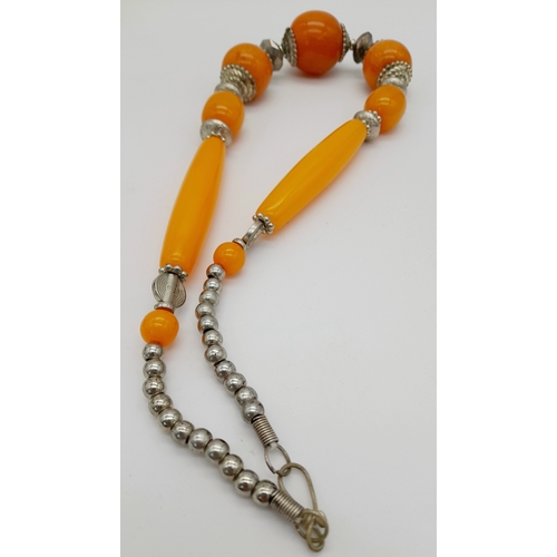 665 - A graduated orange Berber resin necklace with metal accents, and matching 925 silver earrings. Appro... 