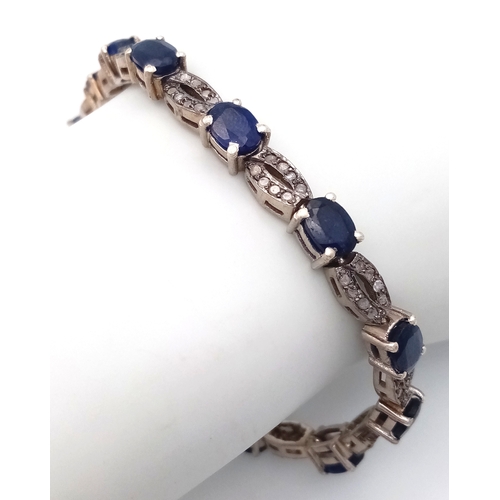 114 - A Blue Sapphire and Old Cut Diamond Bracelet. Set in 925 Silver. 13 oval cut sapphires. 19cm. 19.2g.... 