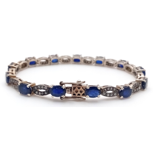 114 - A Blue Sapphire and Old Cut Diamond Bracelet. Set in 925 Silver. 13 oval cut sapphires. 19cm. 19.2g.... 