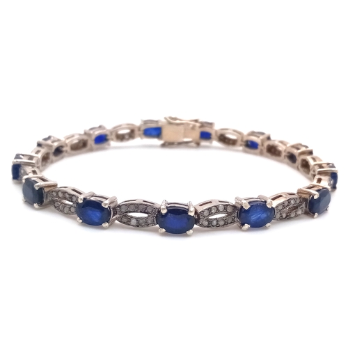 114 - A Blue Sapphire and Old Cut Diamond Bracelet. Set in 925 Silver. 13 oval cut sapphires. 19cm. 19.2g.... 