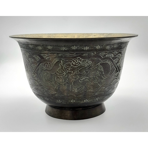 115 - An Antique Bronze Chinese Pedestal Bowl. Decorative dragon engravings. Interesting mark on base. 26c... 