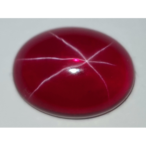 178 - A spectacular STAR RUBY, oval cabochon shaped, lab created, with vivid colour saturation, strong rea... 