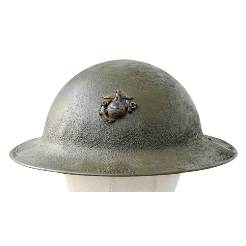 194 - A WW1 US Brodie Helmet, no liner with a USMC Badge adhered to the front. Nice straight WW1 Helmet wi... 