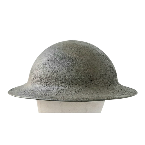 194 - A WW1 US Brodie Helmet, no liner with a USMC Badge adhered to the front. Nice straight WW1 Helmet wi... 