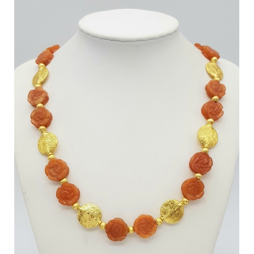 234 - A glamorous, carved carnelian necklace and earrings set with vermeil parts. Necklace length: 52 cm, ... 