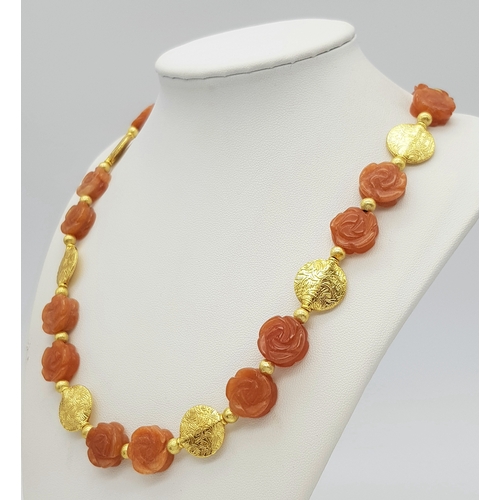 234 - A glamorous, carved carnelian necklace and earrings set with vermeil parts. Necklace length: 52 cm, ... 