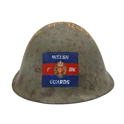 96 - An Original 1980’s British Mk IV Helmet with a hand painted memorial to the 1st Battalion of the Wel... 