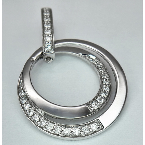 552 - AN 18K WHITE GOLD DIAMOND SET SWIRL PENDANT - 0.16CT. 2.3G. SC5097.