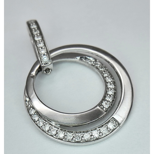 552 - AN 18K WHITE GOLD DIAMOND SET SWIRL PENDANT - 0.16CT. 2.3G. SC5097.