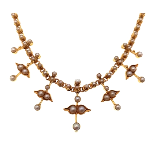 121 - An Antique 15K Gold (tested) Seed Pearl Floral Necklace. A gold link chain gives way to hanging seed... 