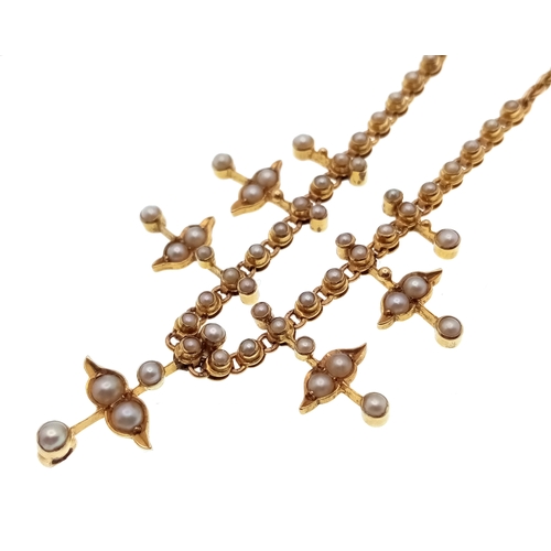 121 - An Antique 15K Gold (tested) Seed Pearl Floral Necklace. A gold link chain gives way to hanging seed... 