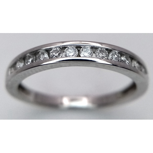 156 - AN 18K WHITE GOLD DIAMOND HALF ETERNITY RING - 0.28CTW.  2.5G. SIZE M. SC5083.