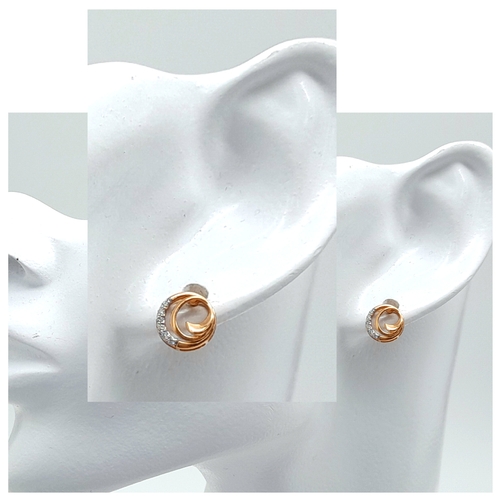 191 - A PAIR OF 18K ROSE GOLD DIAMOND SET SWIRL STUD EARRINGS. 2.1G. SC5092.