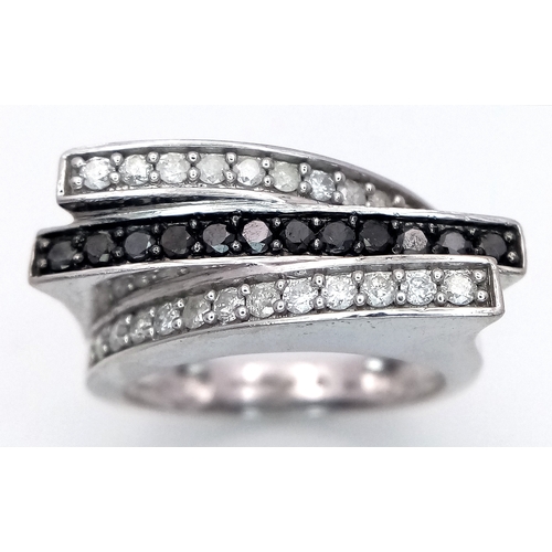 223 - A 9K WHITE GOLD 3 ROW DIAMOND RING - BLACK AND WHITE DIAMONDS. 5.8G. SIZE N. SC5039