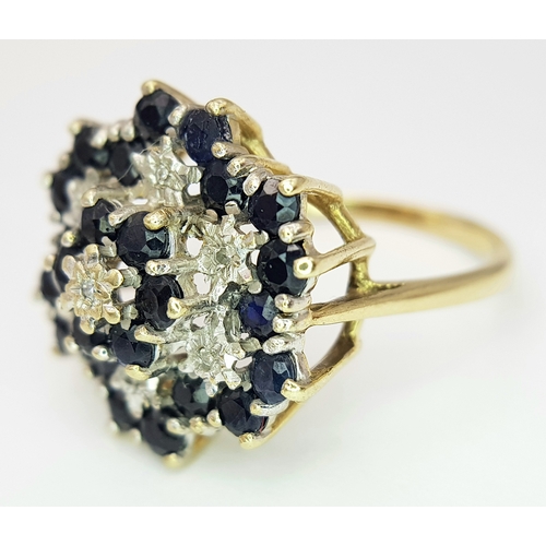 230 - A 9K YELLOW GOLD DIAMOND & SAPPHIRE SET CLUSTER RING. 5G. SIZE U. SC5037.