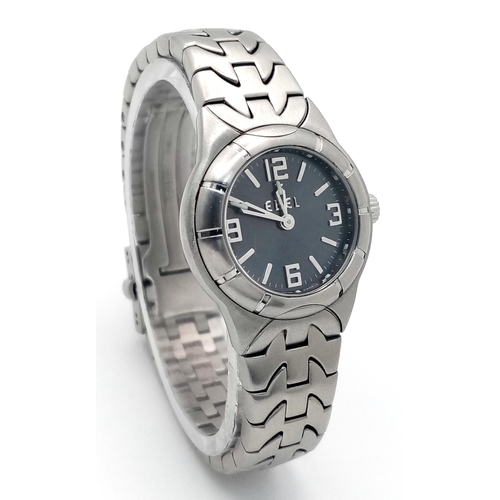 214 - An Ebel Type E Quartz Ladies Watch. Stainless steel bracelet and case - 26mm. Dark grey dial. In wor... 