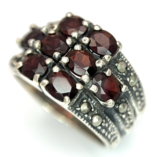 1012 - A Vintage Sterling Silver Garnet and Marcasite Ring Size P. The Ring measures 1.4cm Wide at the Crow... 