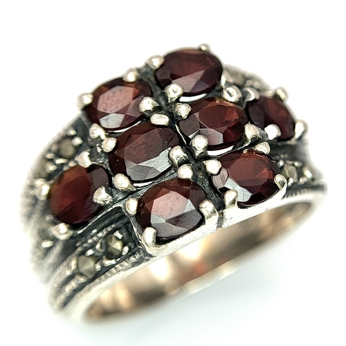1012 - A Vintage Sterling Silver Garnet and Marcasite Ring Size P. The Ring measures 1.4cm Wide at the Crow... 
