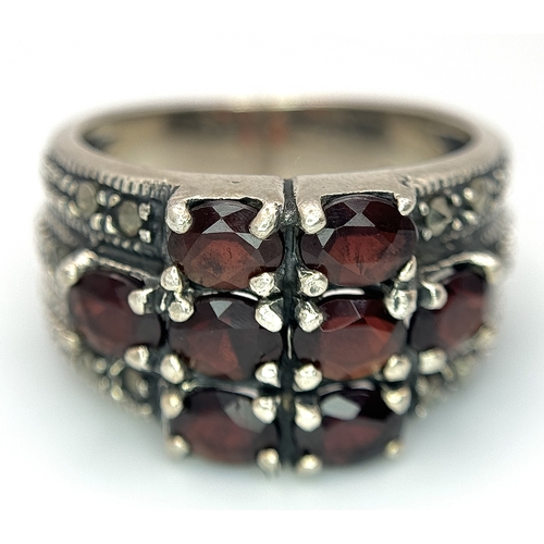 1012 - A Vintage Sterling Silver Garnet and Marcasite Ring Size P. The Ring measures 1.4cm Wide at the Crow... 