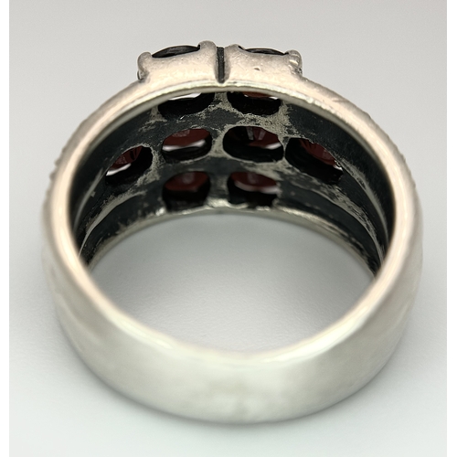 1012 - A Vintage Sterling Silver Garnet and Marcasite Ring Size P. The Ring measures 1.4cm Wide at the Crow... 