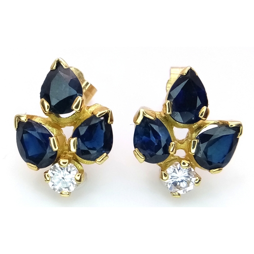 79 - A Pair of 9K Gold, Sapphire and Diamond Floral Form Stud Earrings. 15mm. 2.86g