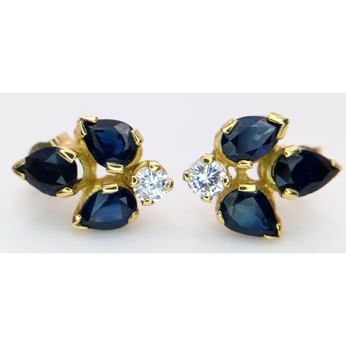 79 - A Pair of 9K Gold, Sapphire and Diamond Floral Form Stud Earrings. 15mm. 2.86g