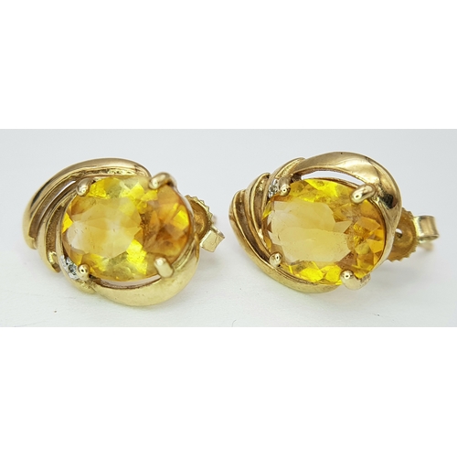 86 - A Pair of Abstract Citrine and Diamond earrings. 17mm. 3.05g