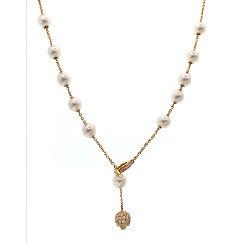 87 - An Italian 18K Gold and Pearl Necklace. A string of ten pearls lead to a gold and diamond circular c... 