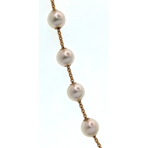 87 - An Italian 18K Gold and Pearl Necklace. A string of ten pearls lead to a gold and diamond circular c... 