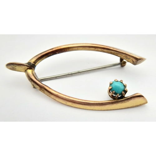 83 - An Antique 9K Rose Gold and Turquoise Wishbone brooch. Pin has been replaced. 4cm. 1.55g