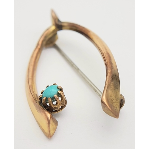 83 - An Antique 9K Rose Gold and Turquoise Wishbone brooch. Pin has been replaced. 4cm. 1.55g