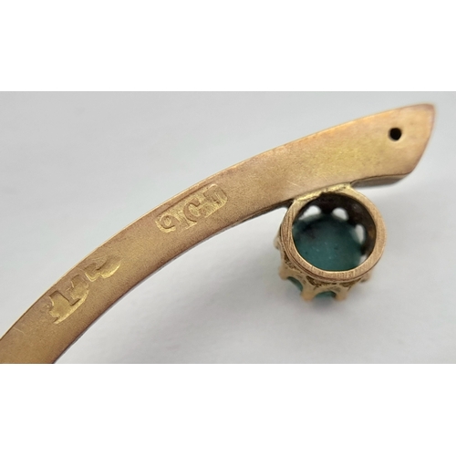 83 - An Antique 9K Rose Gold and Turquoise Wishbone brooch. Pin has been replaced. 4cm. 1.55g