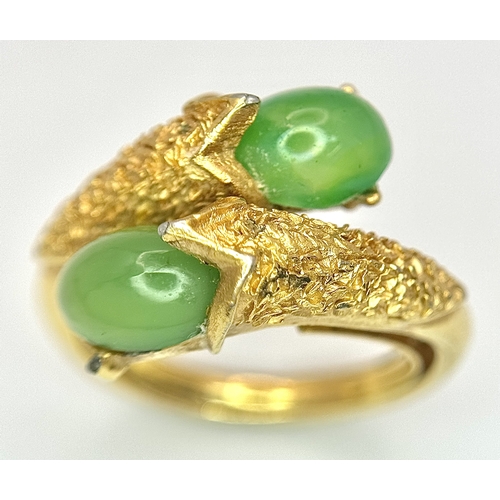 411 - An 18K Gold (tested) Jade Twist Ring. Serpentine in nature with twin jade cabochons. Size O 1/2. 5.3... 