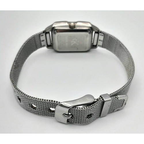 1183 - A Ladies Calvin Klein Tank Style Quartz Watch on a Milanese Bracelet. The Case Measures 30 x 20mm. N... 