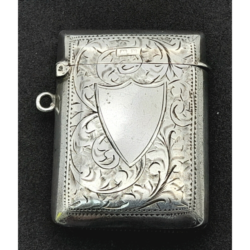 1187 - An antique sterling silver vesta case with floral motif engravings. Full Birmingham hallmarks, 1907.... 