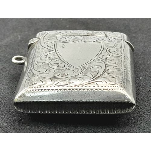 1187 - An antique sterling silver vesta case with floral motif engravings. Full Birmingham hallmarks, 1907.... 