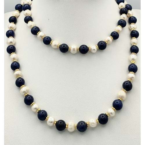 1314 - A Lapis Lazuli and Cultured Pearl Matinee Length Necklace. 72cm