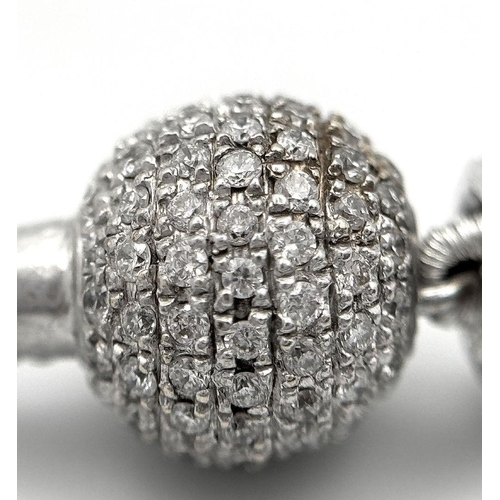 98 - An 18K White Gold, South Sea Pearl Bracelet with Diamond Cluster Spacers. 19.5g total weight.