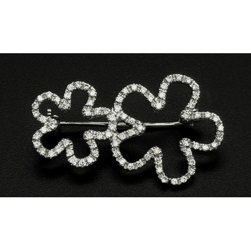 140 - An 18K White Gold and Diamond Brooch. Graduated encrusted stars. 3cm. 4.7g total weight.