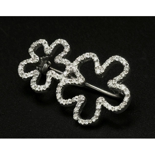 140 - An 18K White Gold and Diamond Brooch. Graduated encrusted stars. 3cm. 4.7g total weight.